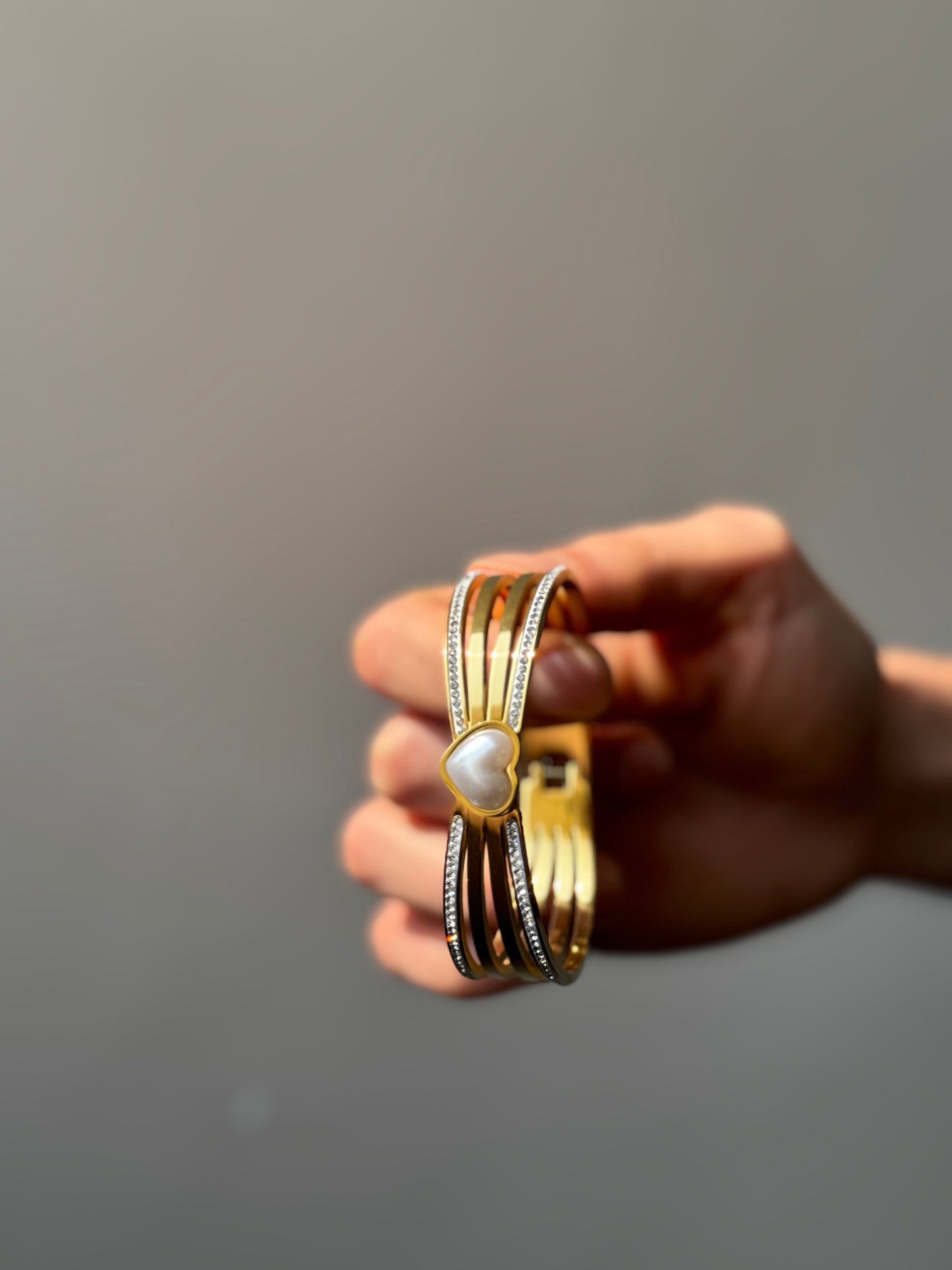 Gold-tone heart accent cuff bracelet with layered band design
