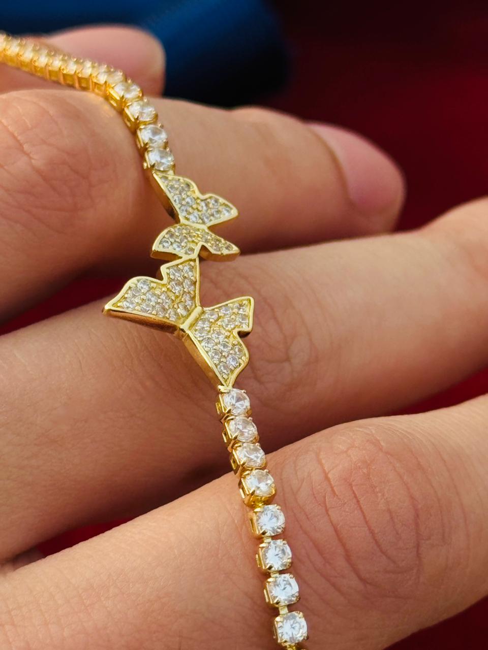 Alt Text
Gold tennis bracelet with three butterfly charms and crystal stones