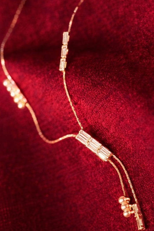 crystal bar necklace arranged on red velvet background