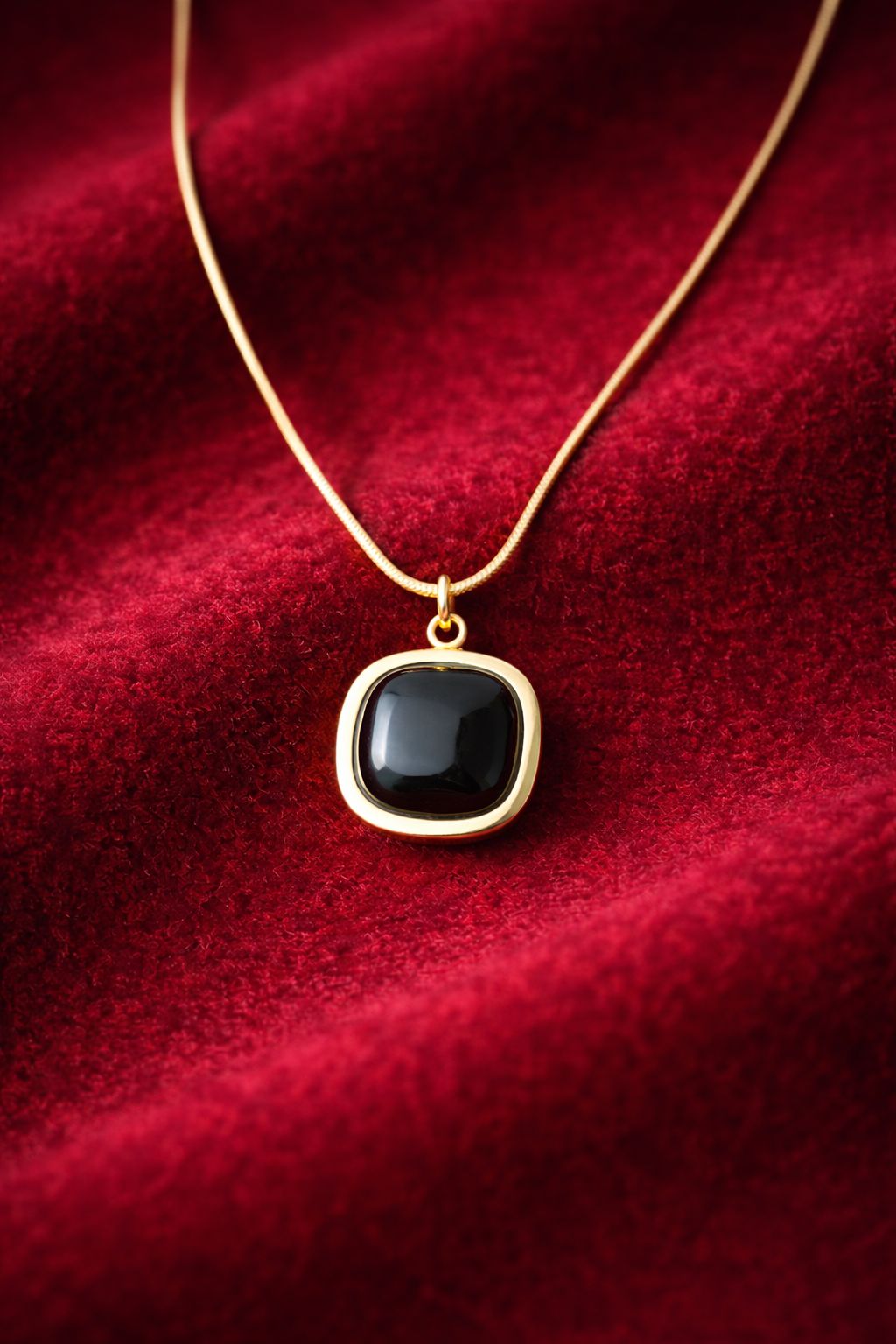 Gold-tone necklace with black  white orange stone pendant